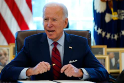 President Joe Biden signs a series of executive orders in the Oval Office, Jan. 28, 2021.