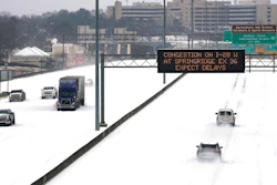 An electronic message board advises drivers of potential congestion on the intersecting interstate as they drive south on Interstate 55 in north Jackson, MS on Feb. 15 as light snow mixed with sleet, and rain continue to cover much of the state.