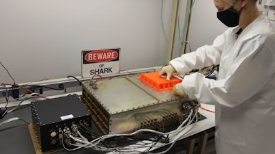 A Northrop Grumman engineer prepares SharkSat for integration with the Cygnus spacecraft.