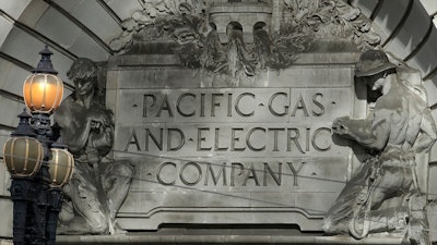In this file photo, a Pacific Gas & Electric sign is shown outside of a PG&E building in San Francisco.
