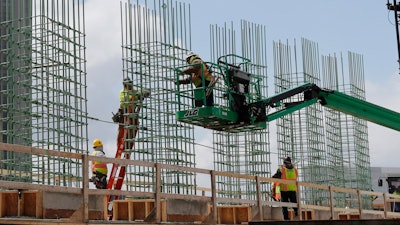 In this April 16, 2020 photo, work continues on a bridge on the Interstate Highway 75 project in Troy, MI.