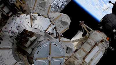 This photo provided by NASA shows US astronaut Kate Rubins outside the International Space Station during a space walk on Friday, March 5, 2021. Rubins and Japan's Soichi Noguchi floated outside to complete unfinished work from Sunday's spacewalk. More mounting brackets and struts need to be installed for new and improved solar panels due to arrive in June.