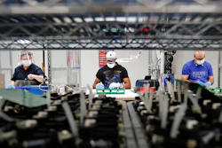 In this May 13, 2020 photo, Ford Motor Co. line workers put together ventilators that the automaker is assembling at the Ford Rawsonville plant in Ypsilanti Township, MI.
