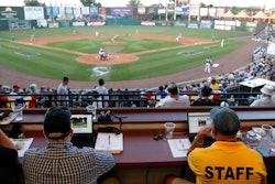 Ron Besaw, right, operates a laptop as home plate umpire Brian deBrauwere gets signals from radar for ball and strike calls during the Atlantic League All-Star Game, York, Pa., July 10, 2019.