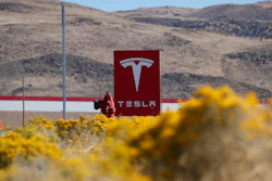 In this Oct. 13, 2018, file photo, a sign marks the entrance to the Tesla Gigafactory in Sparks, Nev. A Russian citizen has pleaded guilty to offering a Tesla employee $1 million to get malware into the electric car company's plant in Nevada and enable a ransomware attack. Attorneys representing Egor Igorevich Kriuchkov did not immediately respond Friday, March 19, 2021, to messages about his Thursday plea in U.S. District Court in Reno.