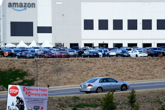 This Feb. 9, 2021 photo file photo, a car enters an Amazon facility where labor is trying to organize workers in Bessemer, Ala. Organizers are pushing for some 6,000 Amazon workers to join the Retail, Wholesale and Department Store Union on the promise it will lead to better working conditions, better pay and more respect. Amazon is pushing back, arguing that it already offers more than twice the minimum wage in Alabama and workers get such benefits as health care, vision and dental insurance without paying union dues.