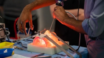 A surgeon performing simulated surgery on an advanced 3D sinus model. Photo by Mark Roe, Fusetec.
