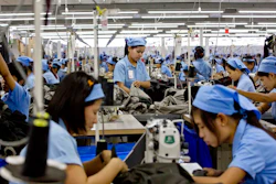 In this Sept. 29, 2015, file photo, workers in the Great Forever factory stitch clothes in the Hlaing Tharyar industrial zone outside Yangon, Myanmar. Garment workers in Myanmar are urging major international brands to denounce the recent military coup there and put more pressure on factories to protect workers from being fired or harassed - or worse arrested and killed for participating in protests.