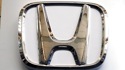 This Feb. 14, 2019 file photo shows a Honda logo at the 2019 Pittsburgh International Auto Show in Pittsburgh. Honda has plans to sell two all-electric SUVs in the U.S. for the 2024 model year, and it soon will offer hybrid gas-electric versions of its top-selling models. The announcements Thursday, March 11, 2021 come as the automaker acknowledges it has work to do to comply with emissions-reduction targets that will be coming from the Biden administration, and a California ban on sales of new internal-combustion vehicles by 2035.