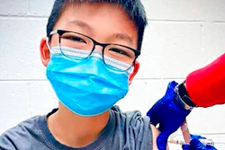 In this Dec. 22, 2020, photo, provided by Richard Chung, his son Caleb Chung receives the first dose of Pfizer coronavirus vaccine or placebo as a trial participant for kids ages 12-15, at Duke University Health System in Durham, N.C. Pfizer says its COVID-19 vaccine is safe and strongly protective in kids as young as 12. The announcement Wednesday, March 31, 2021 marks a step toward possibly beginning shots in this age group before the next school year.