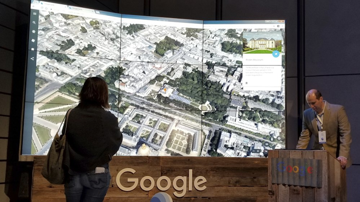 Sean Askay, right, engineering manager with Google Earth, demonstrates its features in New York, April 18, 2017.