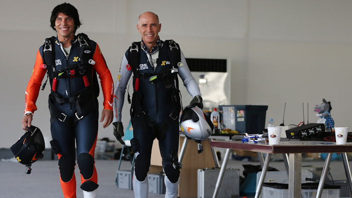 French pilot Vincent Reffet, left, and his mentor Yves Rossy prepare for a fly in Dubai, May 12, 2015.