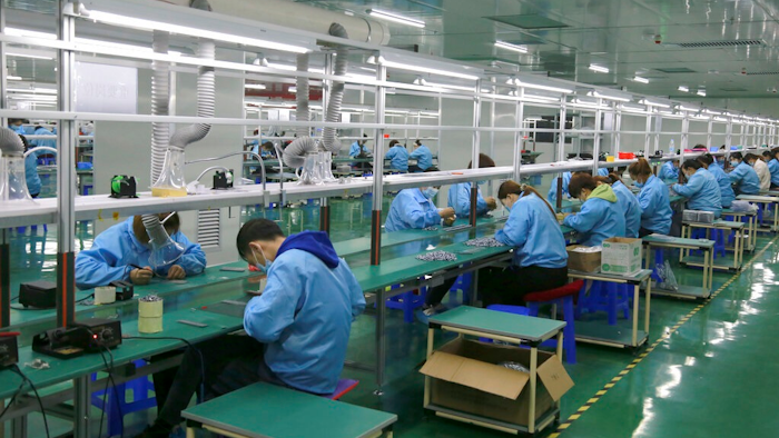 Workers put together electronic gears at a factory in Zhangye in northwestern China's Gansu Province on April 17, 2021. Two surveys show Chinese manufacturing expanded in April but growth appeared to be slowing after a rebound from the coronavirus pandemic.