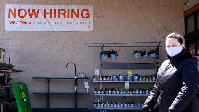 A hiring sign is seen outside home improvement store in Mount Prospect, Ill., Friday, April 2, 2021.