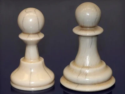 Chess pawns made of the new material with added dark lines to mimic ivory as precisely as possible.