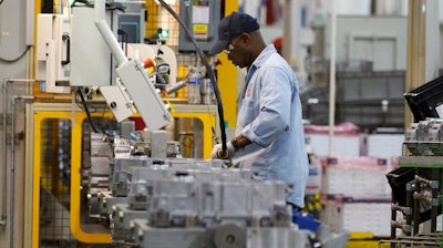 An autoworker assembles a transmission at the General Motors Transmission Plant in Toledo, Ohio.