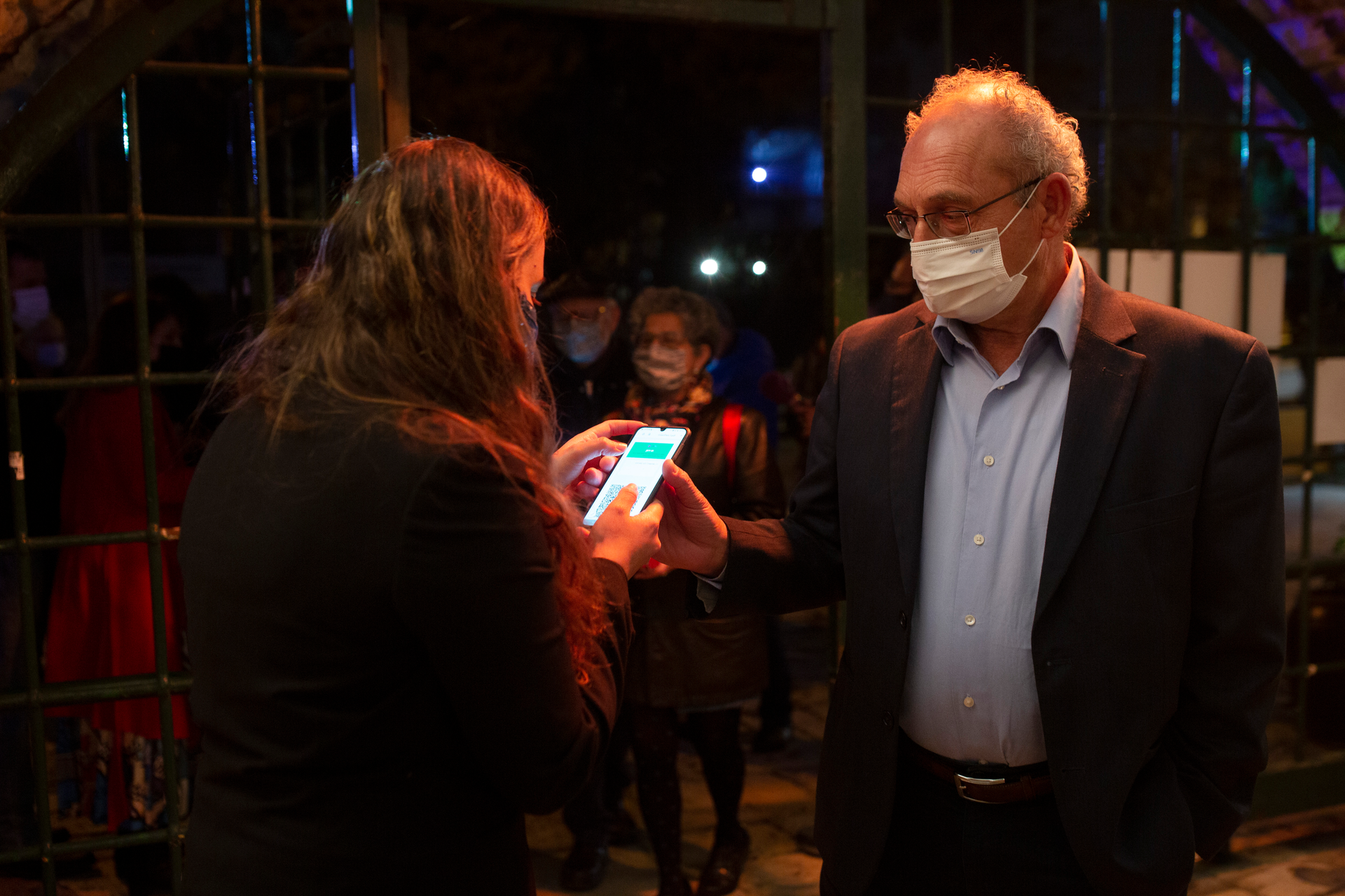 A man presents his 'green passport,' proof that he is vaccinated against the coronavirus, at the Khan Theater, Jerusalem, Feb. 23, 2021.