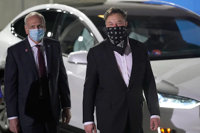 NASA acting administrator Steve Jurczyk, left and SpaceX founder and CEO Elon Musk arrive for the walkout of the SpaceX crew before a launch attempt Friday, April 23, 2021, at the Kennedy Space Center in Cape Canaveral, Fla. Four astronauts will fly on the SpaceX Crew mission to the International Space Station scheduled for launch on April 23, 2021.