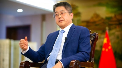 Chinese Vice Minister of Foreign Affairs Le Yucheng speaks during an interview with the Associated Press at the Ministry of Foreign Affairs in Beijing, Friday, April 16, 2021. Le spoke to AP on a wide range of issues during an interview on Friday including climate change and US-China relations.