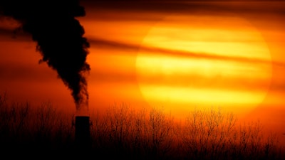 In this file photo, emissions from a coal-fired power plant are silhouetted against the setting sun in Independence, MO.
