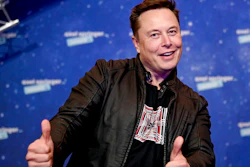 In this Tuesday, Dec. 1, 2020 file photo, SpaceX owner and Tesla CEO Elon Musk arrives on the red carpet for the Axel Springer media award, in Berlin, Germany. Technology mogul Elon Musk has a lined up a new gig in addition to his jobs as CEO of electric car maker Tesla and spaceship maker SpaceX. He is going to host the iconic TV show “Saturday Night Live ' on May 8, 2021.