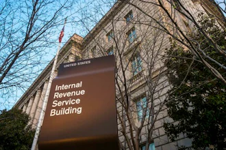 In this April 13, 2014 file photo, the Internal Revenue Service Headquarters (IRS) building is seen in Washington. More than 50 of the largest U.S. companies paid nothing in federal income taxes last year, even though they reported big pretax profits as a group. That's according to the Institute on Taxation and Economic Policy, a group that believes the tax system needs to raise more revenue.
