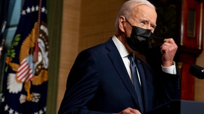 In this Wednesday, April 14, 2021, file photo, President Joe Biden removes his mask to speak at a news conference at the White House, in Washington. Ten liberal senators are urging Biden to back India and South Africa’s appeal to the World Trade Organization to temporarily relax intellectual property rules so coronavirus vaccines can be manufactured by nations that are struggling to inoculate their population.