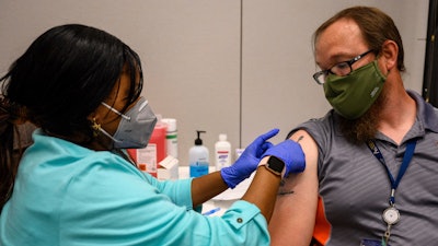 Universities and other employers are encouraging workers to get vaccinated by doing it on site.