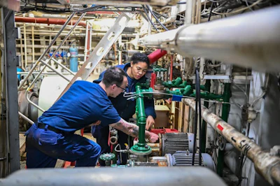 Engineers aboard the Polar Star fix a saltwater pump while in the Bering Sea on Jan. 28, 2021.
