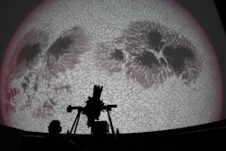 Researcher Ivannia Calvo, silhouetted against a solar satellite image, works inside the Solar Astronomical Observatory in San Jose, Costa Rica, April 30, 2021.