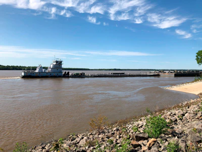 A tugboat with a barge attached sits near a boat ramp at Meeman-Shelby Forest State Park, Wednesday, May 12, 2021, in Millington, Tenn. A crack in the Interstate 40 bridge linking Tennessee and Arkansas has shut down Mississippi River traffic near Memphis, forcing tugs that are hauling barges to wait until they receive clearance that it's safe to pass under the closed bridge.