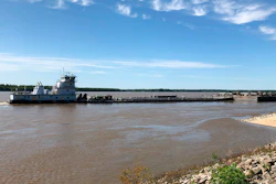 A tugboat with a barge attached sits near a boat ramp at Meeman-Shelby Forest State Park, Wednesday, May 12, 2021, in Millington, Tenn. A crack in the Interstate 40 bridge linking Tennessee and Arkansas has shut down Mississippi River traffic near Memphis, forcing tugs that are hauling barges to wait until they receive clearance that it's safe to pass under the closed bridge.
