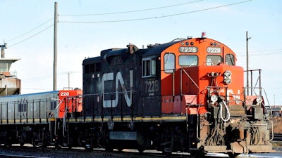 A Canadian National locomotive goes through the Canadian National Taschereau yard in Montreal, Saturday, Nov. 28, 2009. Canadian National sweetened its offer to buy Kansas City Southern railroad Thursday, May 13, 2021, and derailed rival Canadian Pacific’s bid for the railroad that handles traffic in the United States and Mexico.
