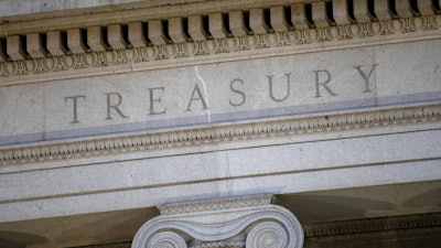 This file photo shows the U.S. Treasury Department building at dusk in Washington.