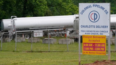 Tanker trucks are parked near the entrance of Colonial Pipeline Company in Charlotte, NC.