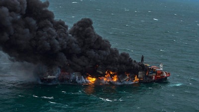 In this photo provided by Sri Lanka Air Force, smoke rises from the container vessel MV X-Press Pearl engulfed in flames off Colombo port, Sri Lanka, Tuesday, May 25, 2021. An explosion occurred Tuesday on a ship anchored off Sri Lanka's capital on which a fire had been burning for several days, prompting the evacuation of all crew members, officials said.