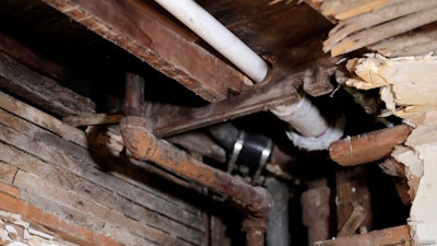 A lead pipe (left) seen through a hole in the kitchen ceiling in the home of Desmond Odom, in Newark, New Jersey.