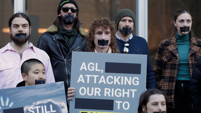 Greenpeace supporters demonstrate outside the Federal Court in Sydney, Wednesday, June 2, 2021. Australia's largest electricity generator on Tuesday, June 8, 2021, largely lost its court case alleging that the environmental group Greenpeace had breached copyright and trademark laws by using its logo in a campaign that described the company as the nation's 'biggest climate polluter.'