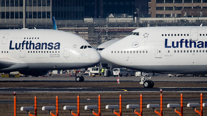 In this Feb. 14, 2019 photo, an Airbus A380, left, and a Boeing 747, both from Lufthansa airline pass each other at the airport in Frankfurt, Germany.