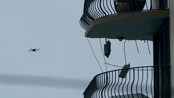 Search and rescue personnel use a drone to inspect the upper floors of the remaining portion of the Champlain Towers South Condo building.
