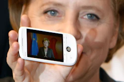 German Chancellor Angela Merkel holds a cell phone at the CeBIT in Hanover, March 3, 2009.