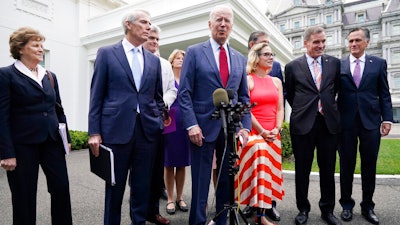 President Joe Biden, with a bipartisan group of senators, speaks Thursday June 24, 2021, outside the White House in Washington. Biden invited members of the group of 21 Republican and Democratic senators to discuss the infrastructure plan. From left are, Sen. Jeanne Shaheen, D-N.H., Sen. Rob Portman, R-Ohio, Sen. Bill Cassidy, R-La., Sen. Lisa Murkowski, R-Alaska, Biden, Sen, Joe Manchin, D-W.Va., rear, Sen. Kyrsten Sinema, D-Ariz, Sen. Mark Warner, D-Va., and Sen. Mitt Romney, R-Utah.