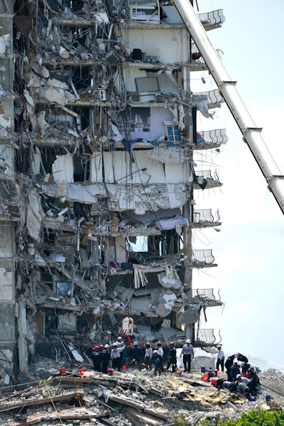 Rescue workers search the rubble of the Champlain Towers South condominium, Saturday, June 26, 2021, in the Surfside area of Miami. The building partially collapsed on Thursday.