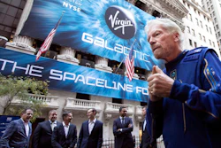 In this Monday, Oct. 28, 2019 file photo, Richard Branson, right, founder of Virgin Galactic, and company executives gather for photos outside the New York Stock Exchange before his company's IPO. In an interview after the Wednesday, June 30, 2021 satellite launch by his separate company Virgin Orbit, Branson said that he has to be “so circumspect” in what he says about Virgin Galactic. “All I can say is when the engineers tell me that I can go to space, I’m ready, fit and healthy to go. So we’ll see,” he said.