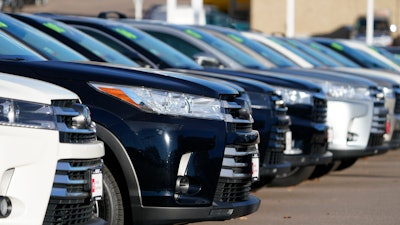 This Nov. 15, 2020 photo shows a long row of unsold used Highlander sports-utility vehicles sits at a Toyota dealership in Englewood, Colo. In 2021, high demand and low supply have driven up used vehicle prices so much that many are now selling for more than their original sticker price when they were new.