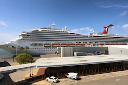 In this Wednesday, May 12, 2021, file photo, the Carnival Cruise ship 'Liberty' is docked at Port Canaveral, Fla., as crew members get vaccinated for COVID-19. Customers and employees of several Carnival Corp. cruise lines might have had personal information stolen.