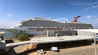 In this Wednesday, May 12, 2021, file photo, the Carnival Cruise ship 'Liberty' is docked at Port Canaveral, Fla., as crew members get vaccinated for COVID-19. Customers and employees of several Carnival Corp. cruise lines might have had personal information stolen.