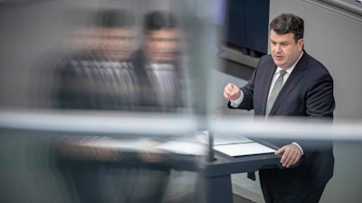German Labour Minister Hubertus Heil speaks during a debate at the German parliament Bundestag in Berlin, Germany, Friday, June 11, 2021. German lawmakers on Friday approved legislation meant to ensure that big companies ensure environmental rules and human rights are respected throughout their supply chains.