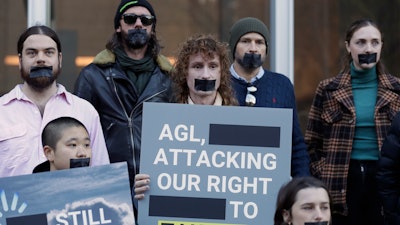 Greenpeace supporters demonstrate outside the Federal Court in Sydney, Wednesday, June 2, 2021. Australia's largest electricity generator on Tuesday, June 8, 2021, largely lost its court case alleging that the environmental group Greenpeace had breached copyright and trademark laws by using its logo in a campaign that described the company as the nation's 'biggest climate polluter.'