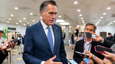Sen. Mitt Romney, R-Utah, speaks to reporters as he walks on the Senate subway on Capitol Hill, Tuesday, June 8, 2021, in Washington.